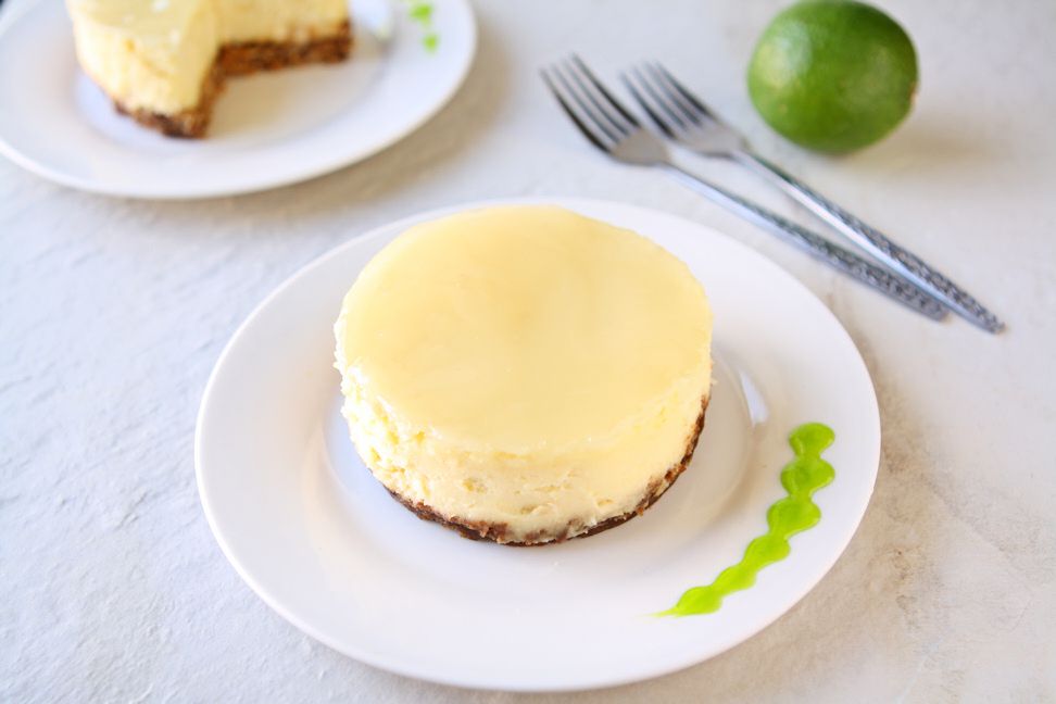 Coconut Cheesecake with Lime Glaze | Smooth coconut cheesecake covered with a refreshing lime glaze baked over a sweet graham cracker crust. Tropical bliss! | heavenlyhomecooking.com
