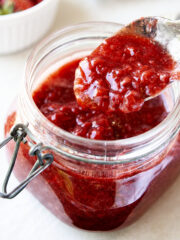 Spoonful of strawberry compote over a compote-filled jar