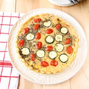 Close up of quiche provencale on a white plate