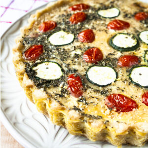 Close up of quiche provencale on a white plate