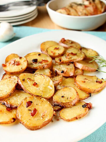 Rosemary oven roasted potatoes on a white platter