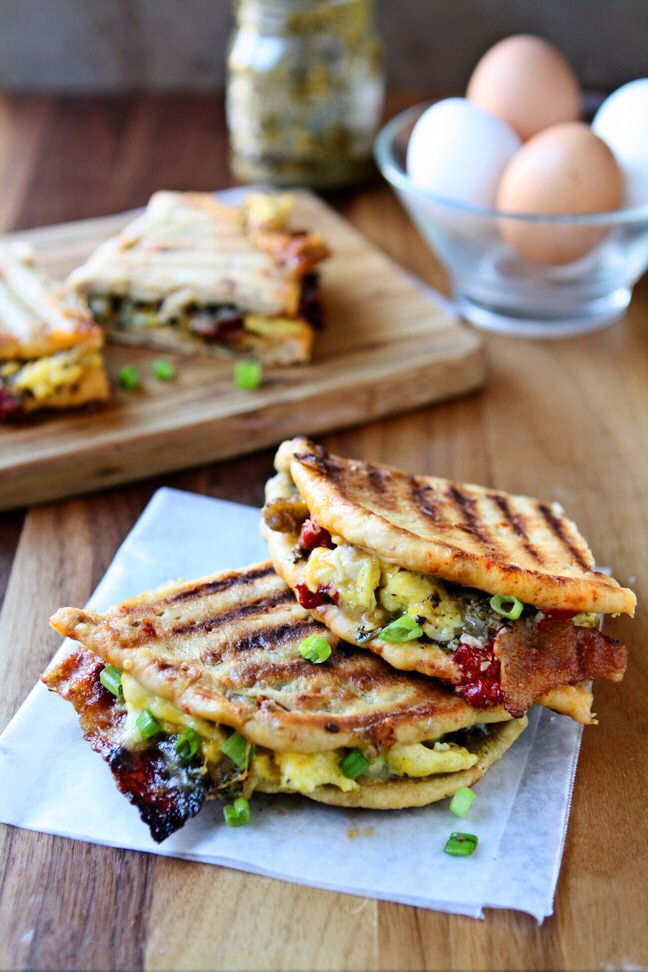 Breakfast Panini | Take your breakfast to the next level! Sun-Dried tomato pita bread, pesto, three kinds of cheese, scrambled eggs, bacon, sausage, roasted red peppers and scallions. A delicious and hearty breakfast sandwich that will keep you going all morning. Ready in less than 30 minutes!| heavenlyhomecooking.com