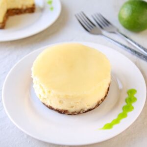 Coconut Cheesecake with Lime Glaze | Smooth coconut cheesecake covered with a refreshing lime glaze over a graham cracker crust. Tropical bliss! | heavenlyhomecooking.com