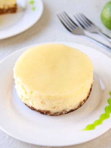Coconut Cheesecake with Lime Glaze | Smooth coconut cheesecake covered with a refreshing lime glaze over a graham cracker crust. Tropical bliss! | heavenlyhomecooking.com