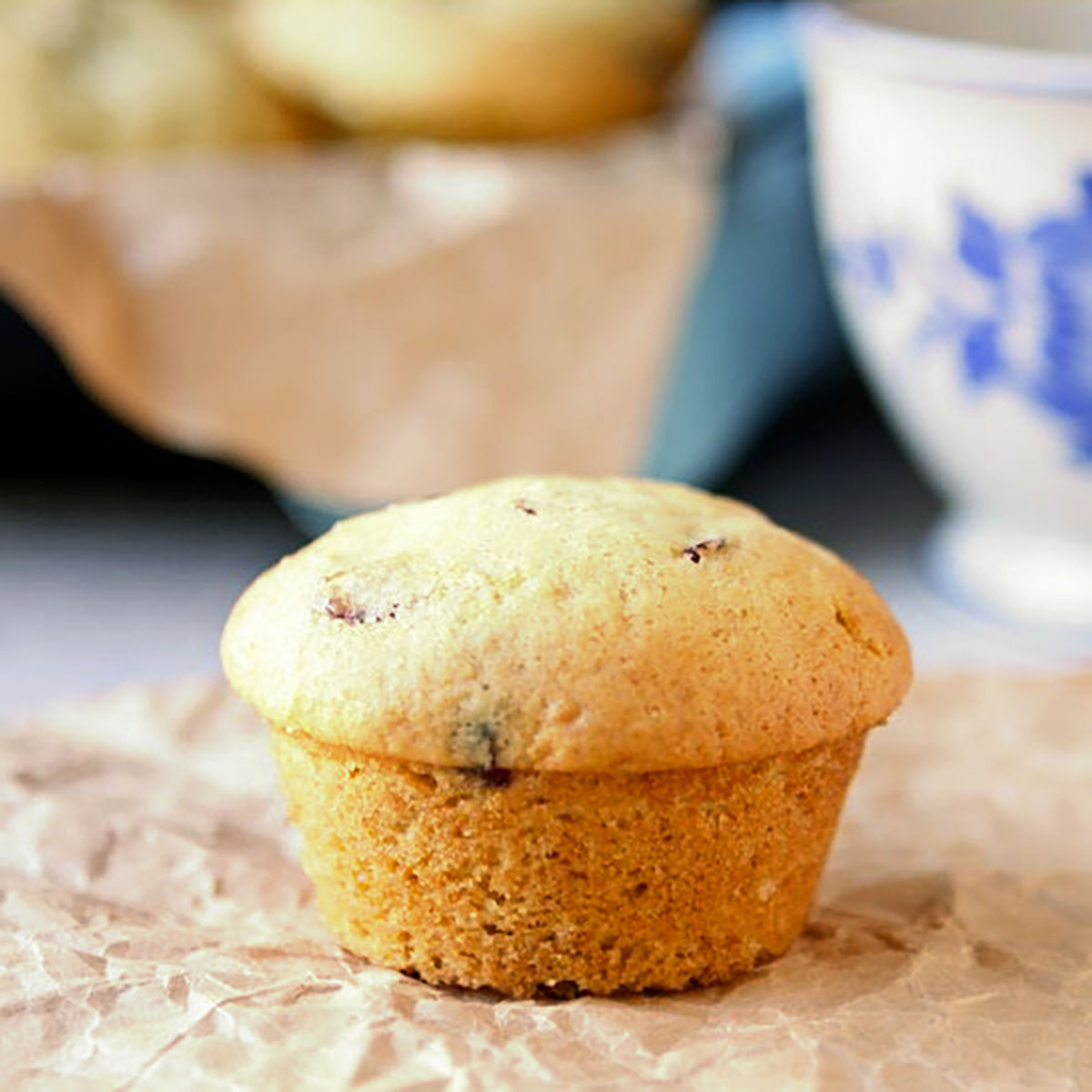 Orange craisin muffin on crinkled paper