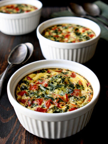 Three ramekins of Italian gnocchi quiche on a table
