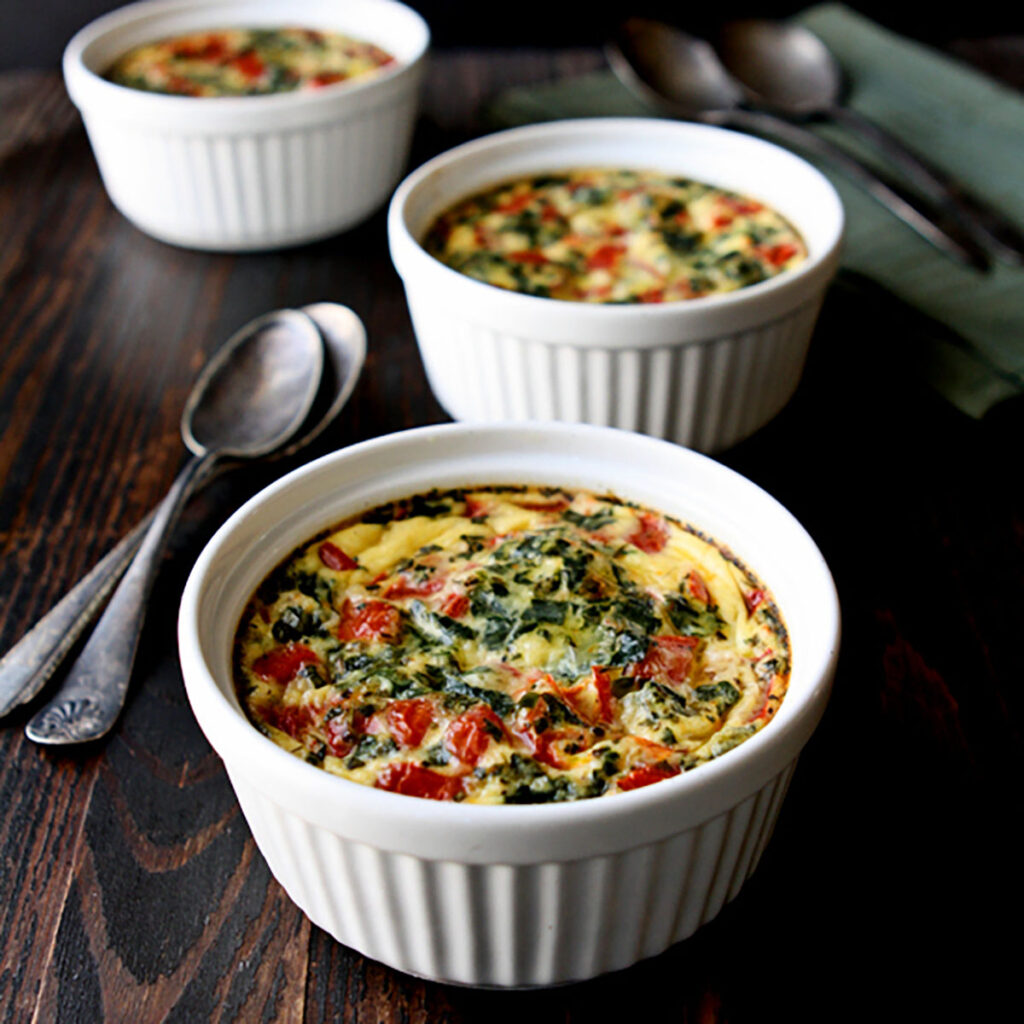 Three ramekins of Italian gnocchi quiche on a table