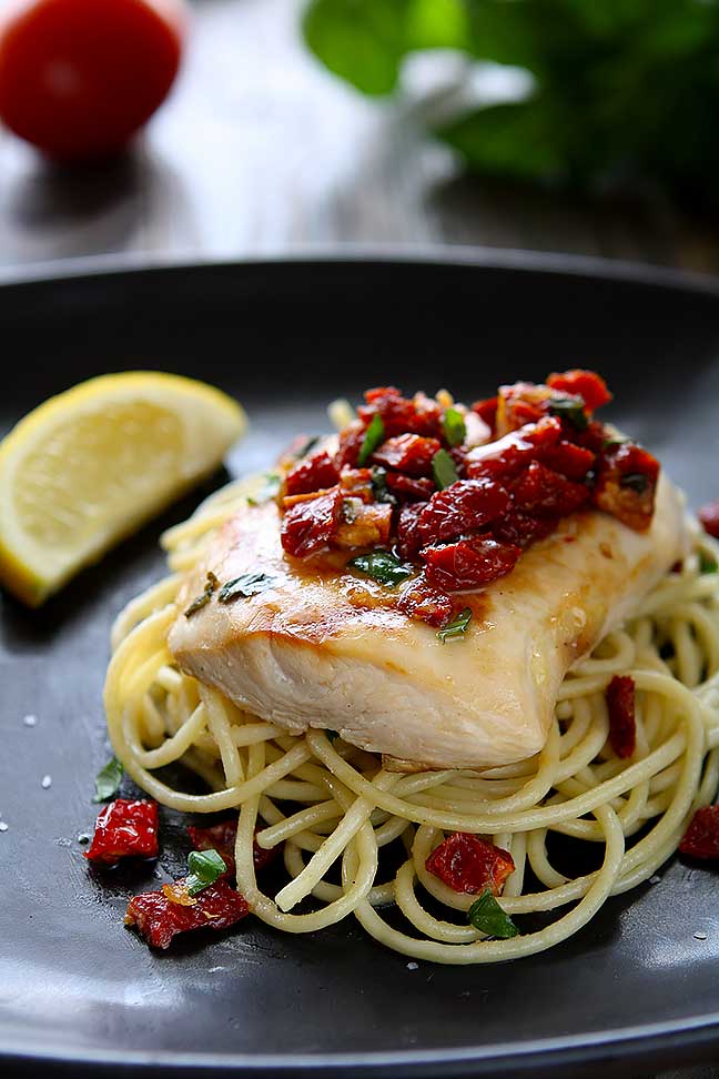 Chicken Bryan (Carrabba's Copycat Recipe) | Simple to prepare but with a huge flavor payoff. Grilled chicken breast on a bed of al dente pasta topped with a sauce of sun-dried tomatoes, fresh basil, butter, garlic, onions, lemon and white wine. Amazing! | www.heavenlyhomecooking.com