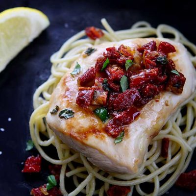 Chicken Bryan (Carrabba's Copycat Recipe) | Simple to prepare but with a huge flavor payoff. Grilled chicken breast on a bed of al dente pasta topped with a sauce of sun-dried tomatoes, fresh basil, butter, garlic, onions, lemon and white wine. Amazing! | www.heavenlyhomecooking.com