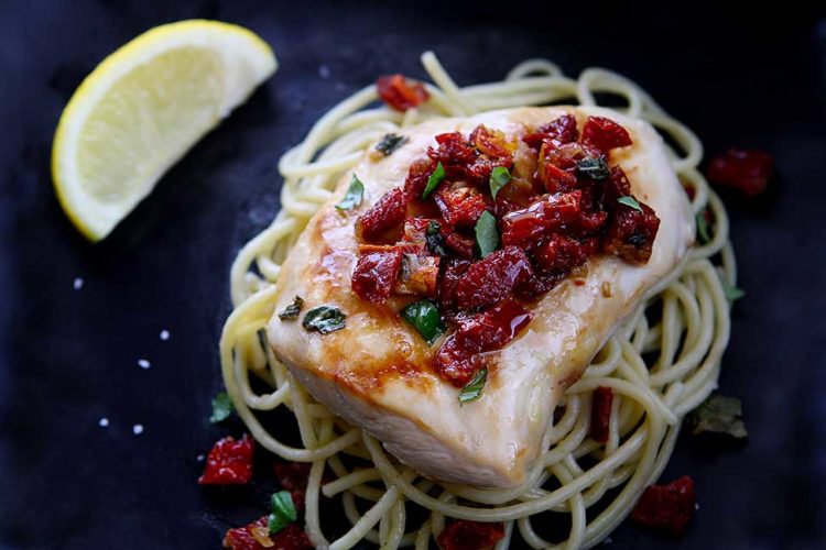 Chicken Bryan (Carrabba's Copycat Recipe) | Simple to prepare but with a huge flavor payoff. Grilled chicken breast on a bed of al dente pasta topped with a sauce of sun-dried tomatoes, fresh basil, butter, garlic, onions, lemon and white wine. Amazing! | www.heavenlyhomecooking.com