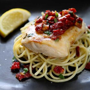 Chicken Bryan (Carrabba's Copycat Recipe) | Simple to prepare but with a huge flavor payoff. Grilled chicken breast on a bed of al dente pasta topped with a sauce of sun-dried tomatoes, fresh basil, butter, garlic, onions, lemon and white wine. Amazing! | www.heavenlyhomecooking.com