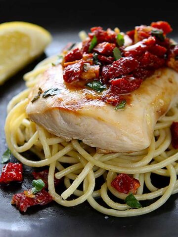Chicken Bryan (Carrabba's Copycat Recipe) | Simple to prepare but with a huge flavor payoff. Grilled chicken breast on a bed of al dente pasta topped with a sauce of sun-dried tomatoes, fresh basil, butter, garlic, onions, lemon and white wine. Amazing! | www.heavenlyhomecooking.com