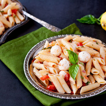 Caprese pasta salad on a silver plate
