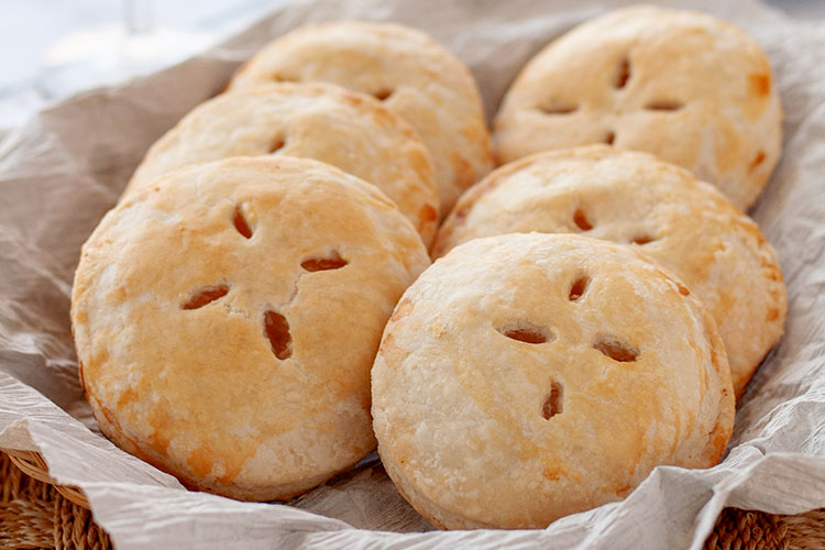 Piña Colada Hand Pies | Think sun, sand and relaxation with the tropical flavors of pineapple, coconut and rum. Enjoy! | www.heavenlyhomecooking.com