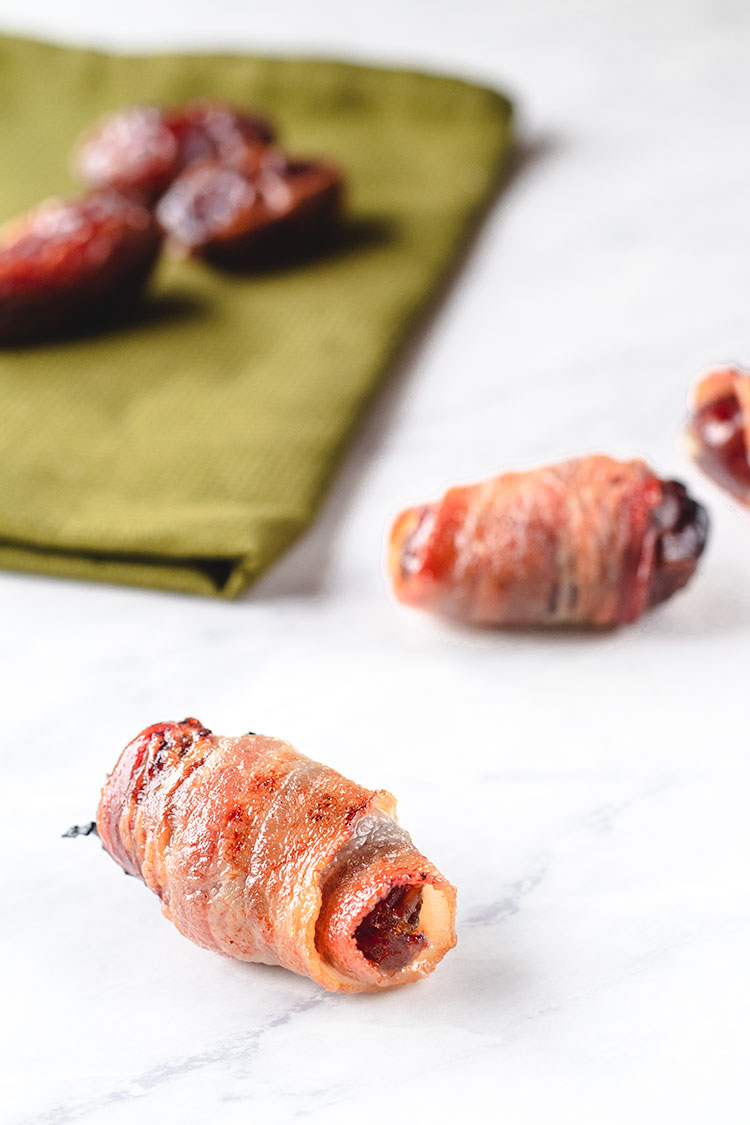 Bacon-Wrapped Dates with Herbed Goat Cheese | These are some of the tastiest appetizers you will ever eat. So easy to make too! | www.heavenlyhomecooking.com