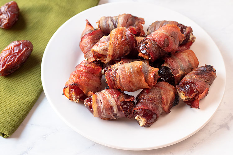 Bacon-Wrapped Dates with Herbed Goat Cheese | These are some of the tastiest appetizers you will ever eat. So easy to make too! | www.heavenlyhomecooking.com