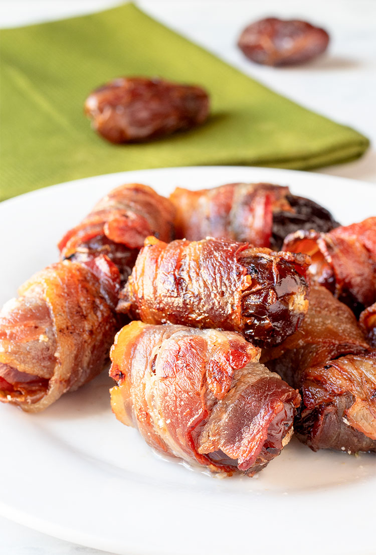 Bacon-Wrapped Dates with Herbed Goat Cheese | These are some of the tastiest appetizers you will ever eat. So easy to make too! | www.heavenlyhomecooking.com