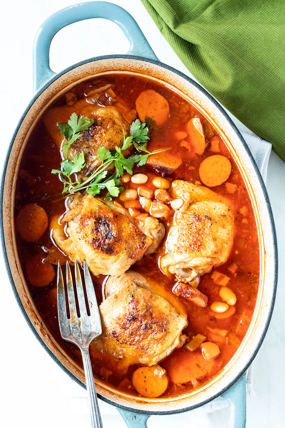 Overhead view of chicken and sausage stew in a Dutch oven