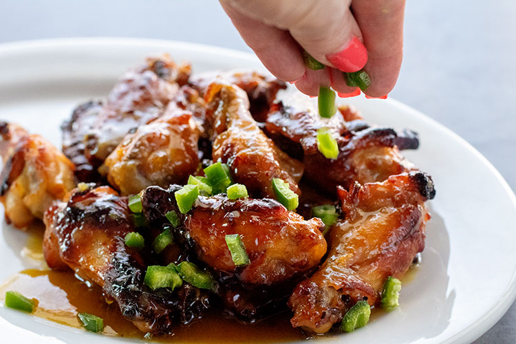 Sweet and Spicy Chicken Wings | Green hot pepper sauce and jalapenos give these wings the spicy, honey gives them the sweet. It's a complementary pairing that will bring you back for more again and again. | www.heavenlyhomecooking.com