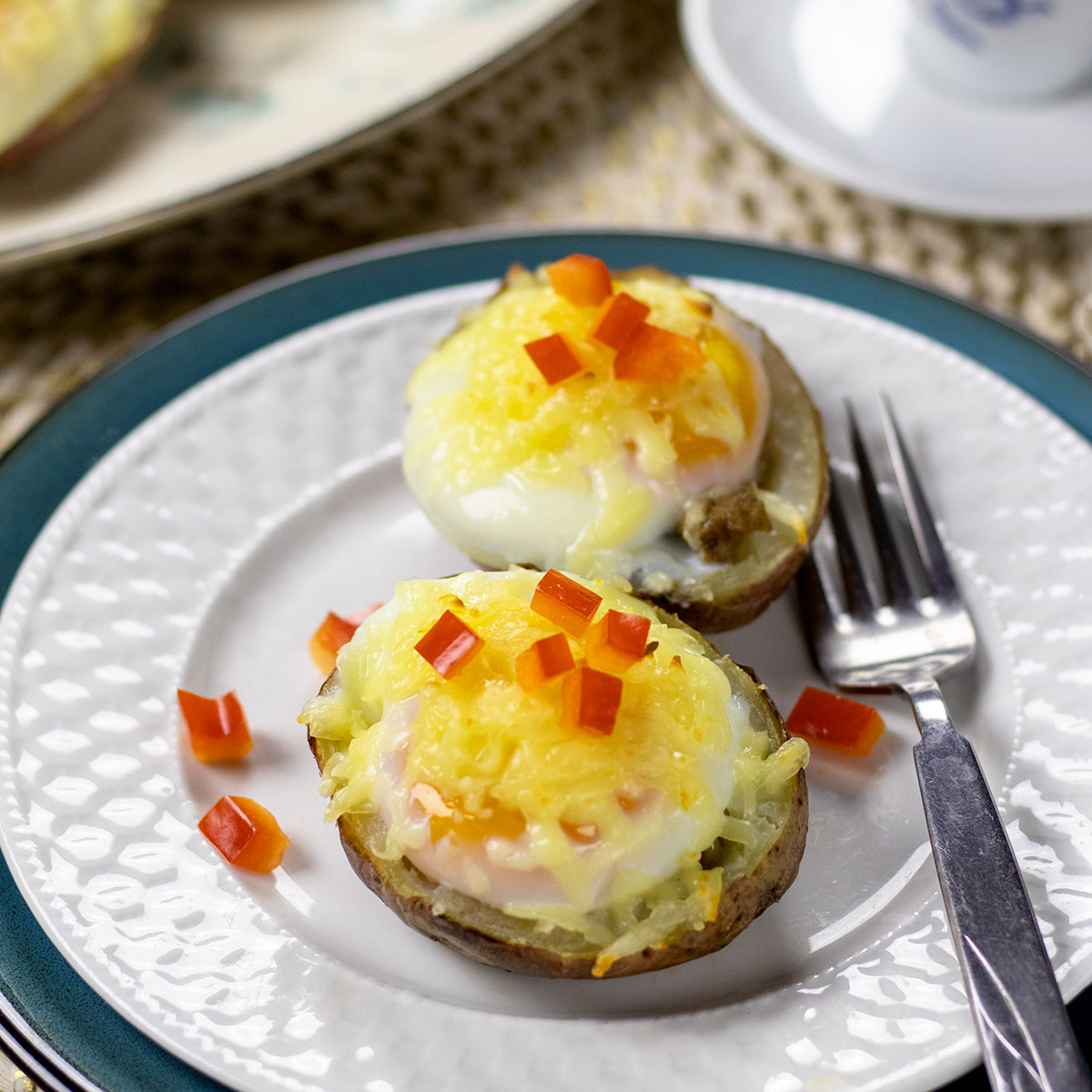 Two healthy potato skins sitting on a white plate