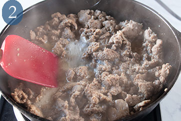 Turkey sausage cooking in a skillet