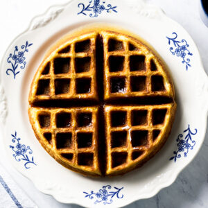 Snickerdoodle waffle sitting on a white and blue floral plate