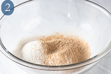 Glass bowl filled with dry ingredients to make buttermilk waffles