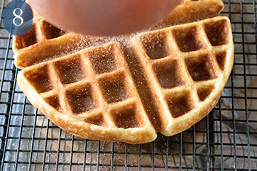 Sprinkling cinnamon sugar on hot waffles