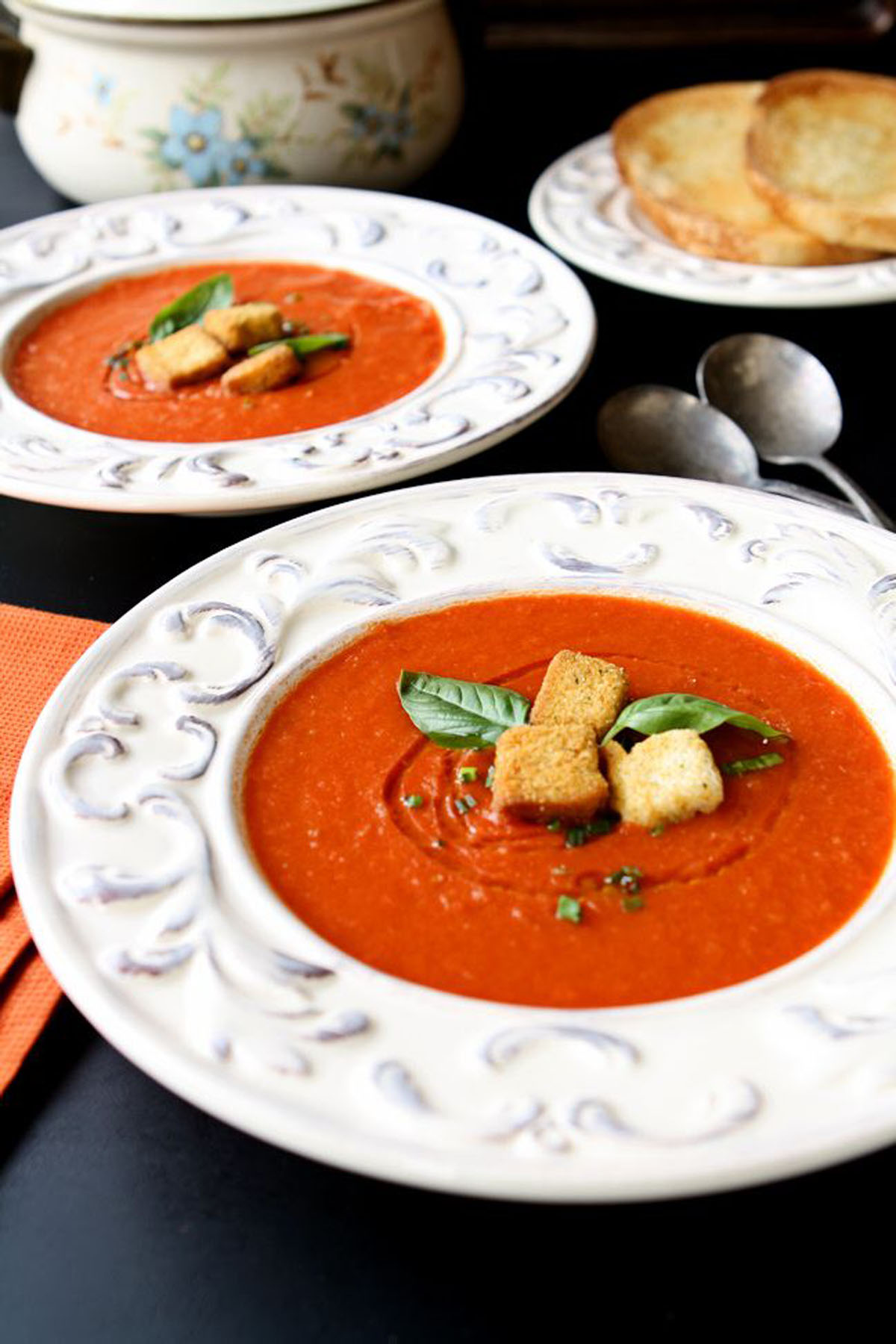 Close up of tomato soup in a white bowl.