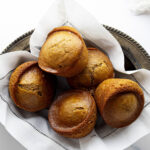 Overhead view of muffins in a napkin-lined bowl