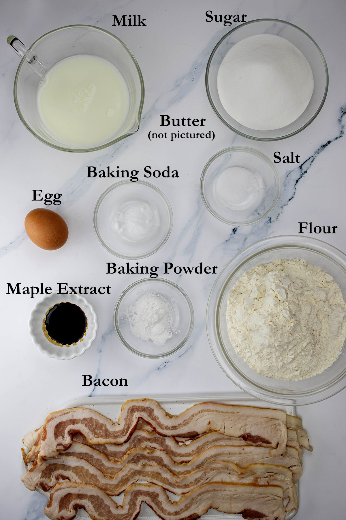 Maple bacon muffin ingredients on a marble countertop