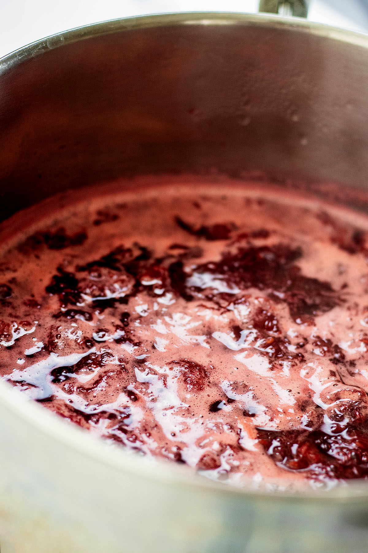 Raspberry syrup cooking in a pan