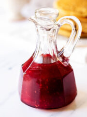 Raspberry syrup in a glass cruet