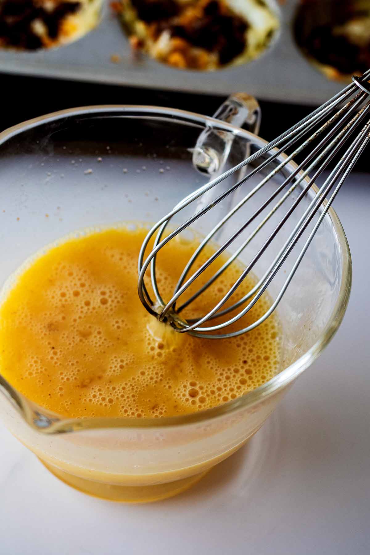Beaten and frothy egg mixture in a glass carafe
