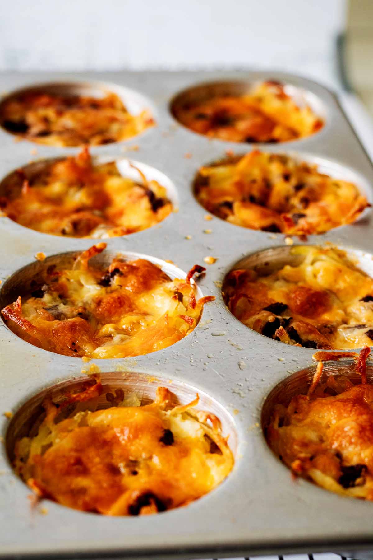 Hash brown egg muffins in a muffin tin fresh out of the oven