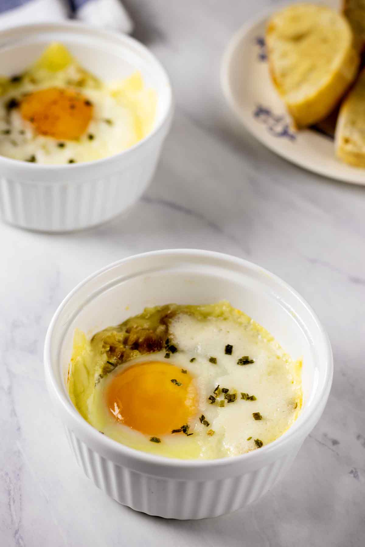 Swiss baked eggs in white ramekins