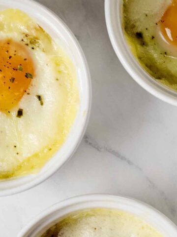 Overhead view of Swiss baked eggs in white ramekins