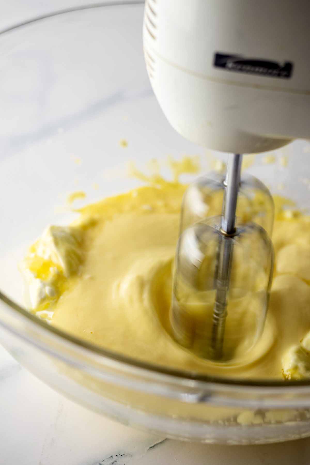 Wet ingredients being beaten with an electric mixer