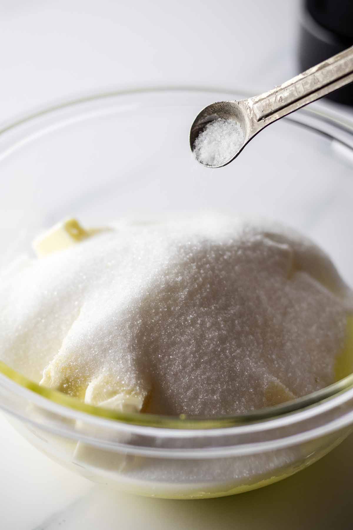 Salt being added to a bowl of ingredients