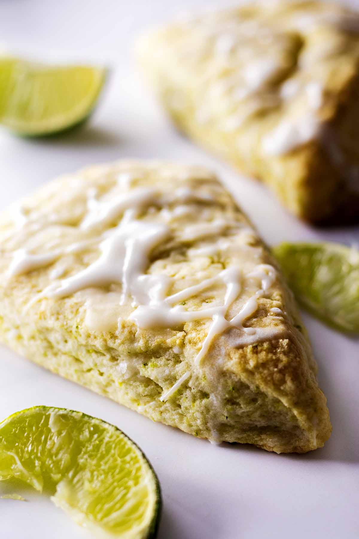 Baked and glazed lime scones with lime wedges