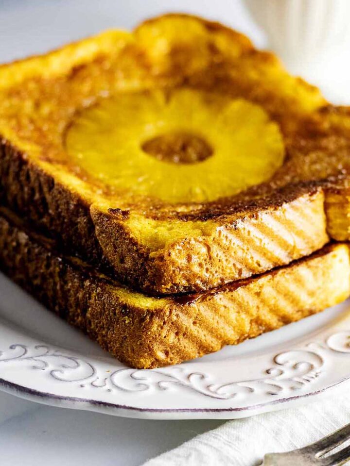 Pineapple French toast on a white plate with a fork