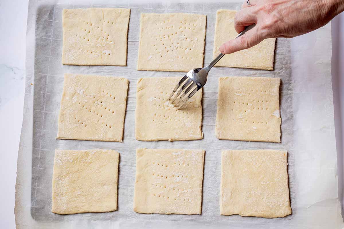 Pricking unbaked puff pastry with a fork