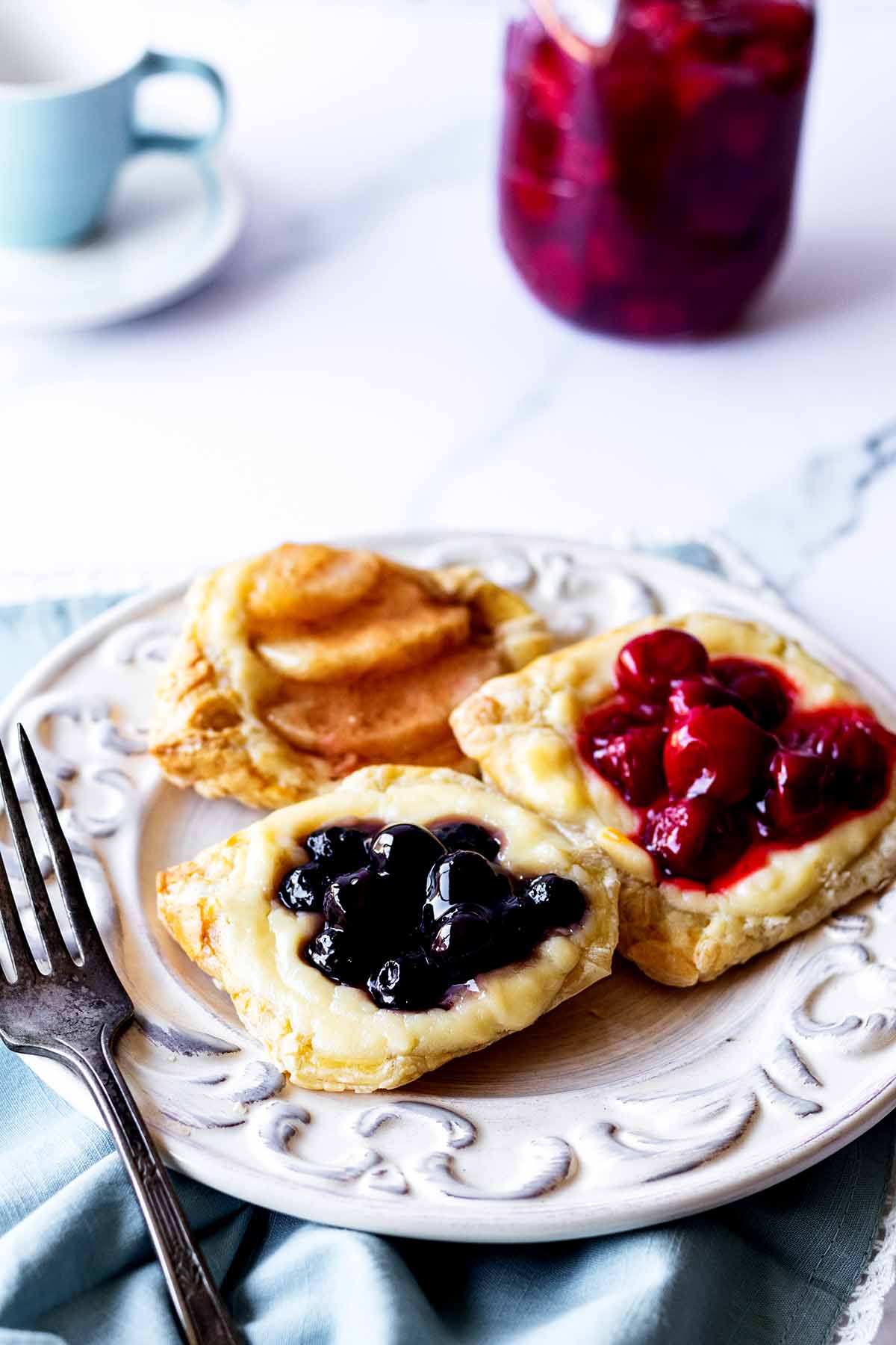 Breakfast pastries on a white plate with a fork