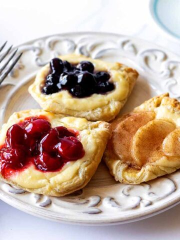 Breakfast pastries on a white plate with a blue napkin