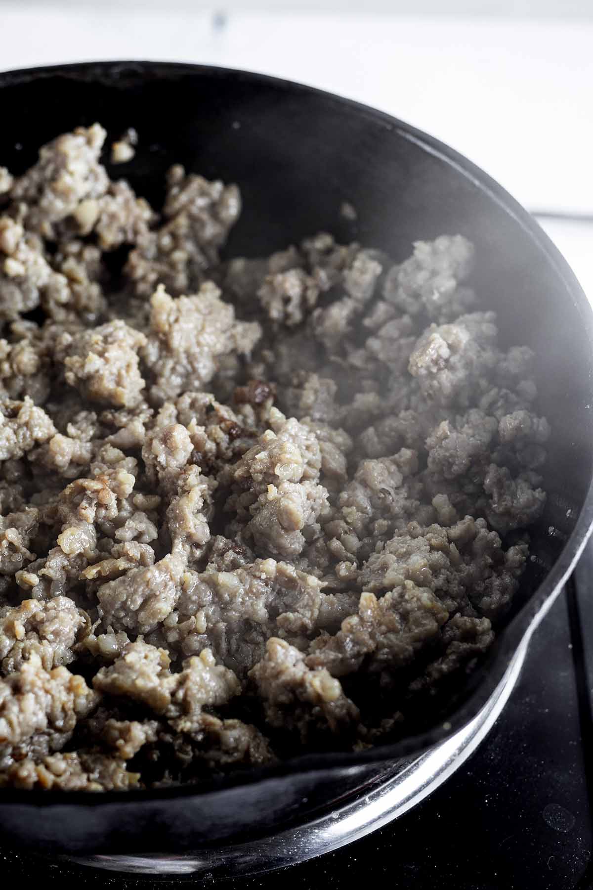 Breakfast sausage cooking in a skillet