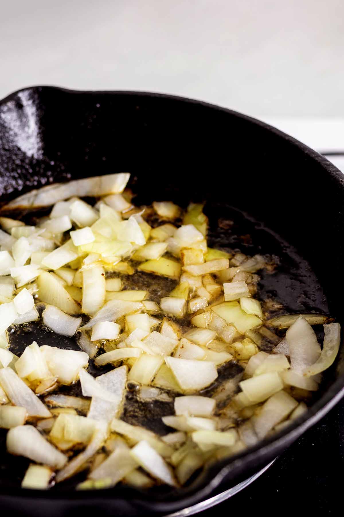 Onions cooking in a cast iron skillet