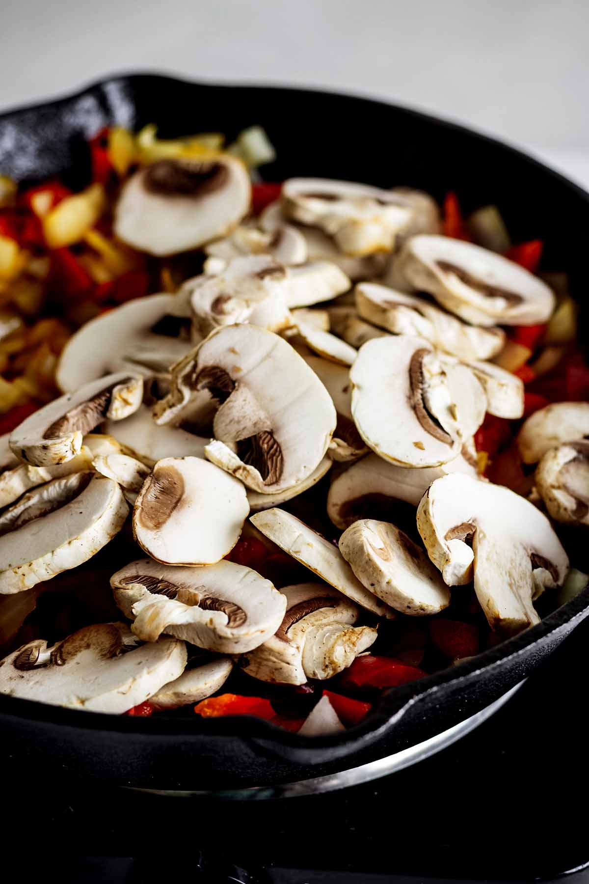 Mushrooms, red pepper and onions cooking in a skillet