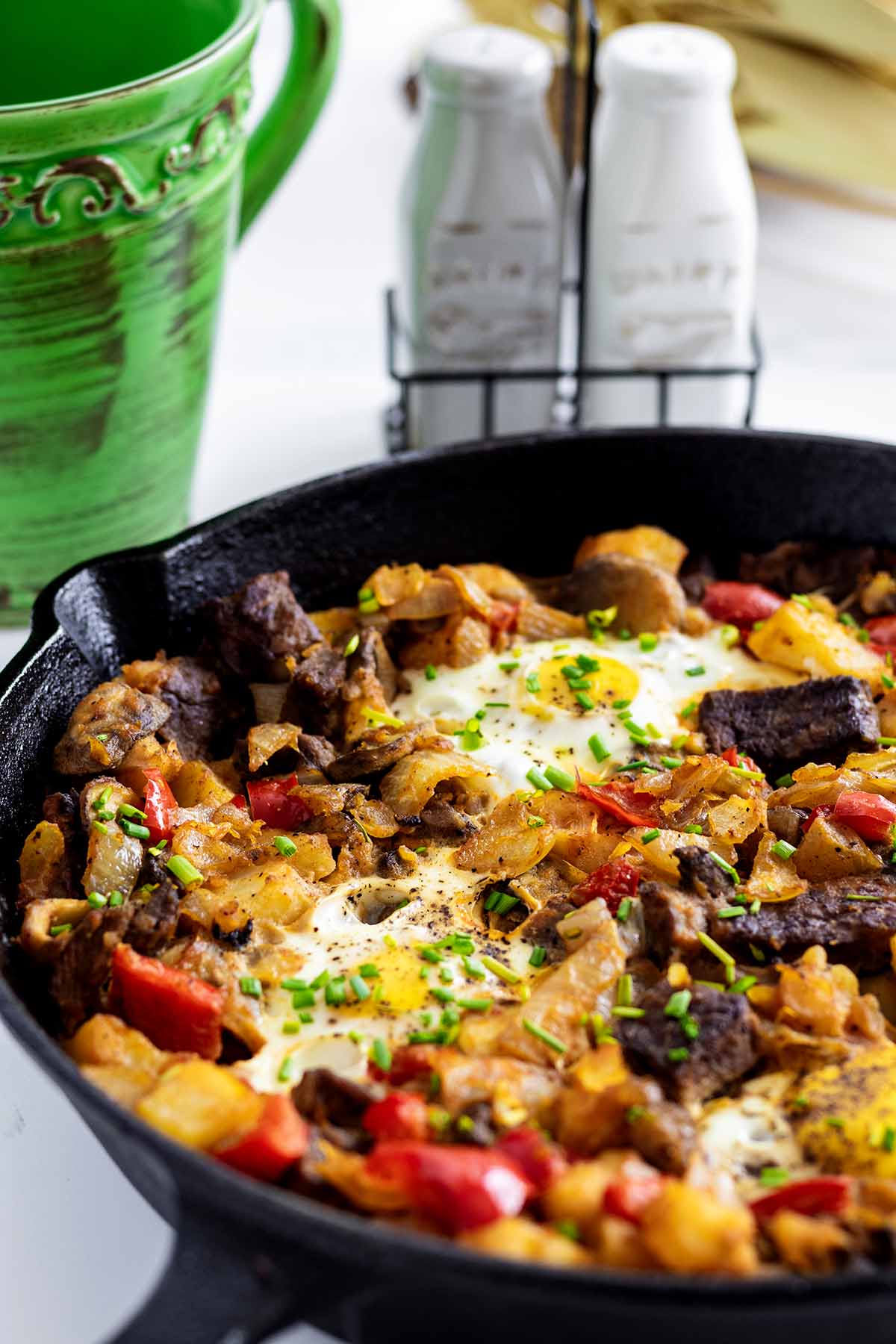 Steak and eggs hash in a cast iron skillet