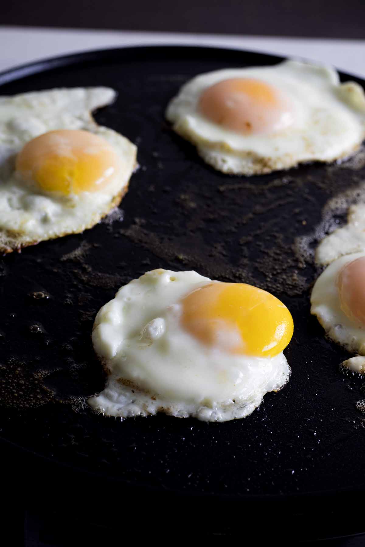 Eggs frying on a griddle