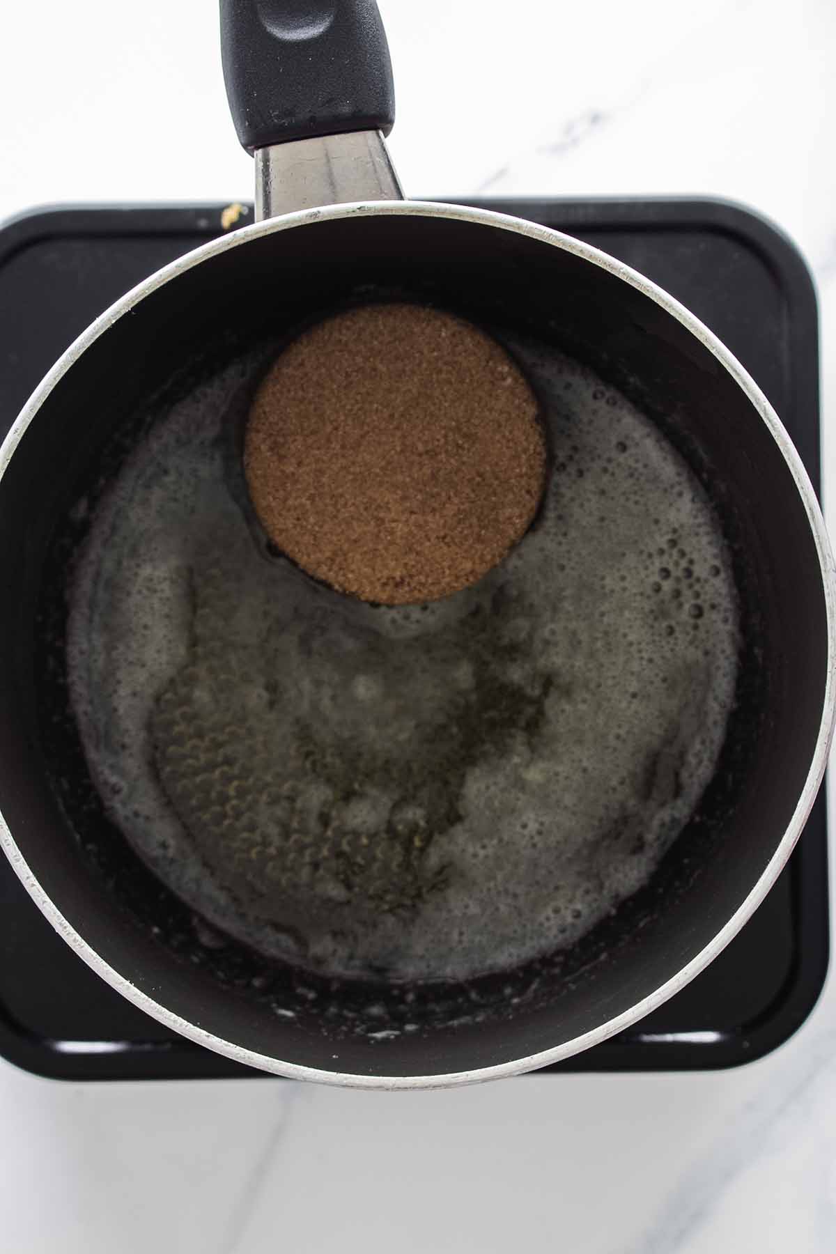 Brown sugar melting in a saucepan
